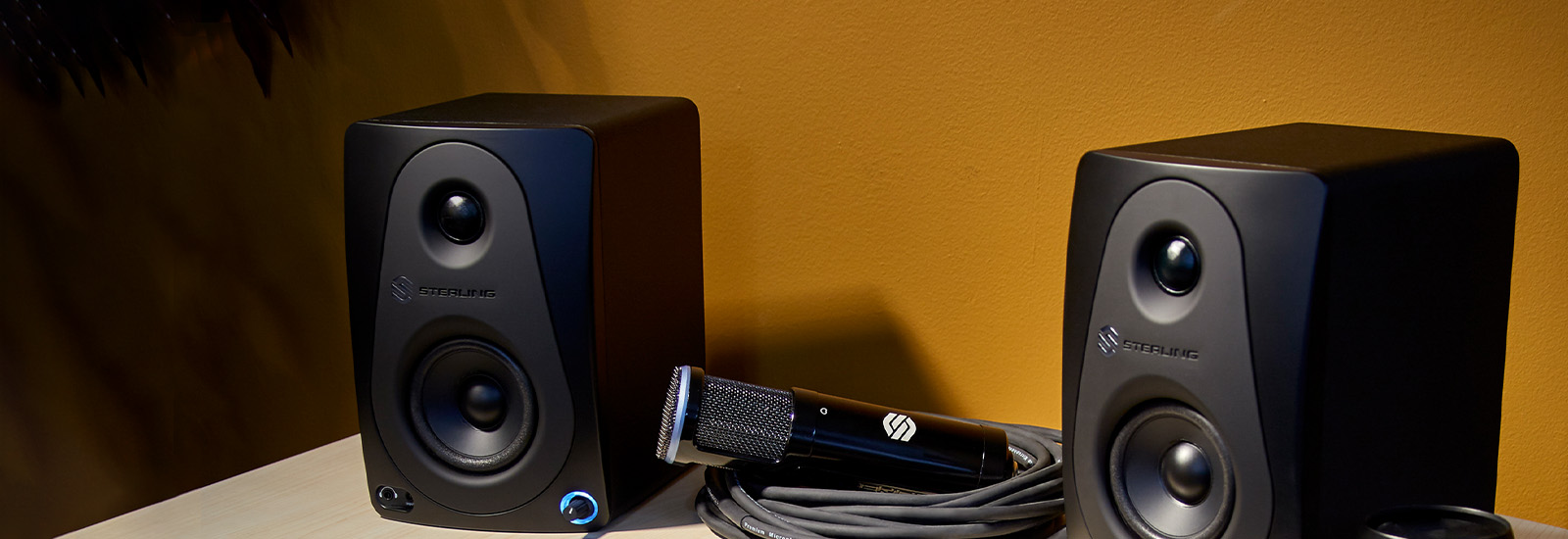 Sterling MX3 3-inch powered studio monitor pair front on the desk close up.