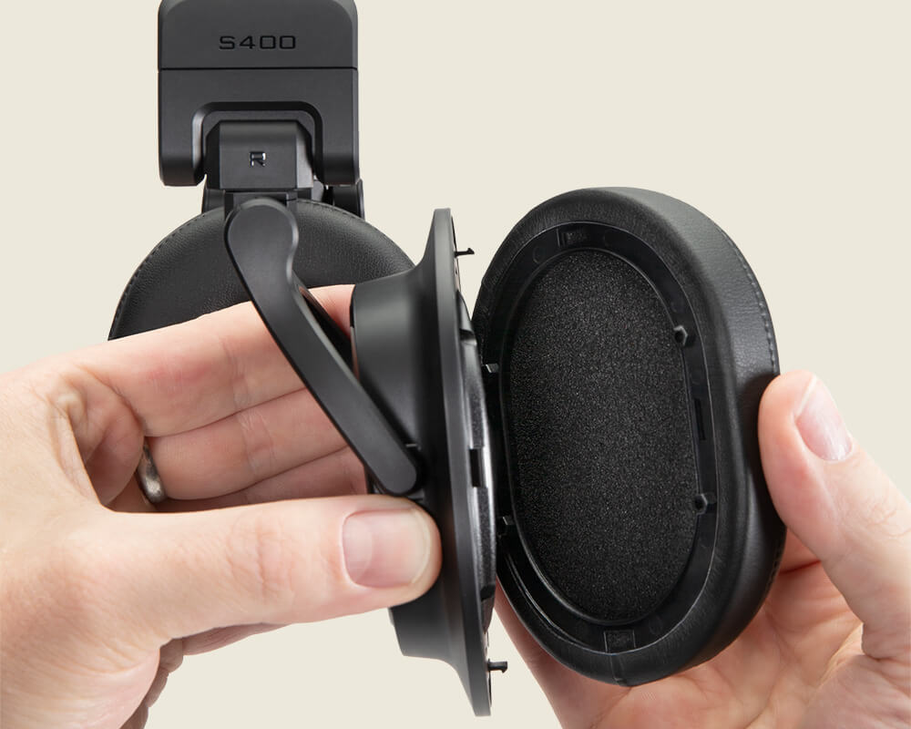 Sterling Audio S400 studio headphone ear cushion remove on light background.